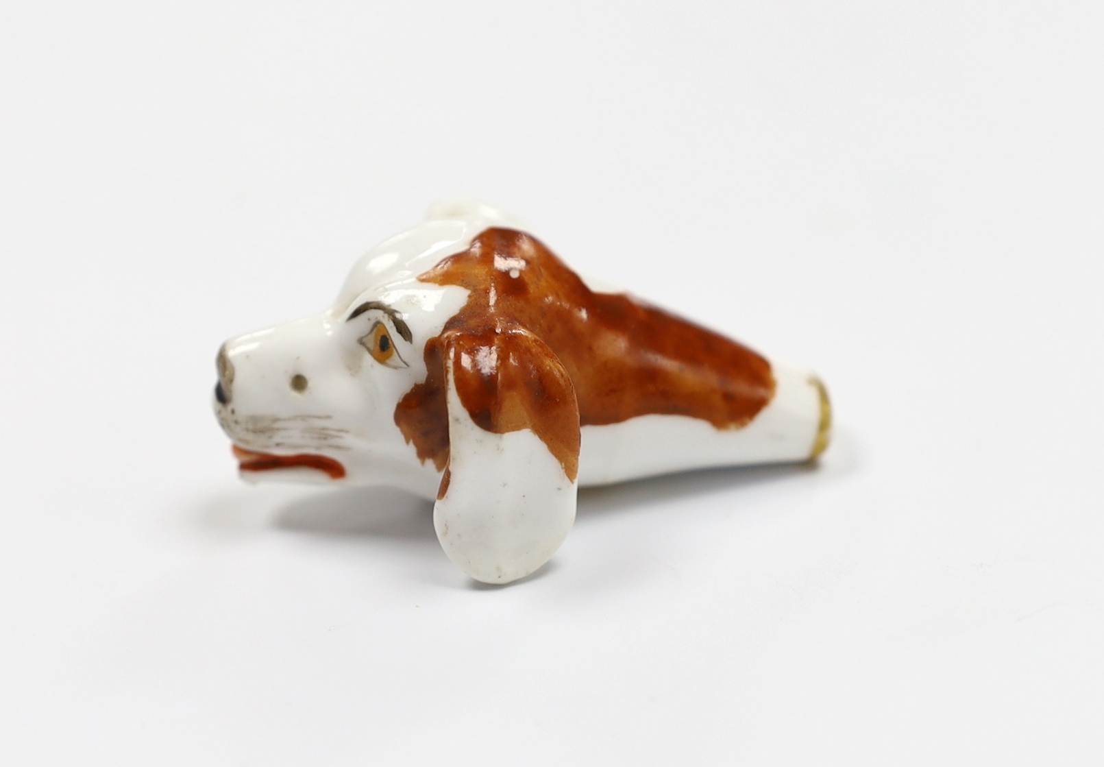 An early 19th century Staffordshire porcelain dog’s head whistle, 5cm